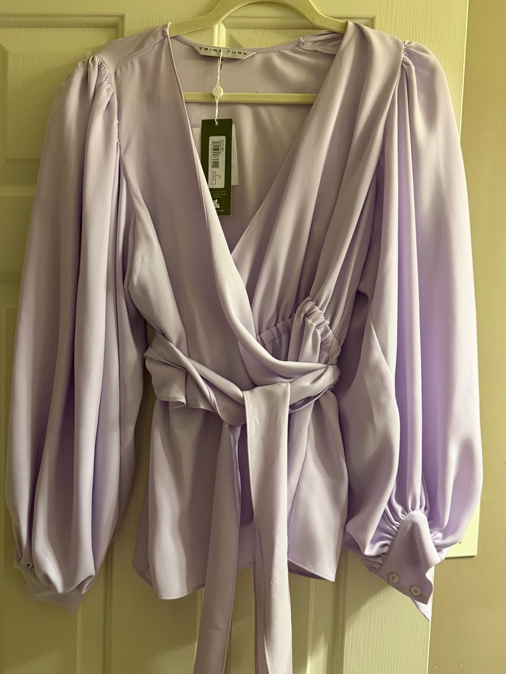 Trina Turk “Aquatic” wrap top in a soft lilac/lavender shade. NWT. Size M